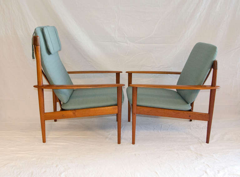 His (high-back) and hers (low-back) Danish teak lounge chairs with a matching ottoman. Many nice details can be seen in pictures, comfortable size, wood curved armrests. Good looking from the sides and back as well. Retains the original Poul