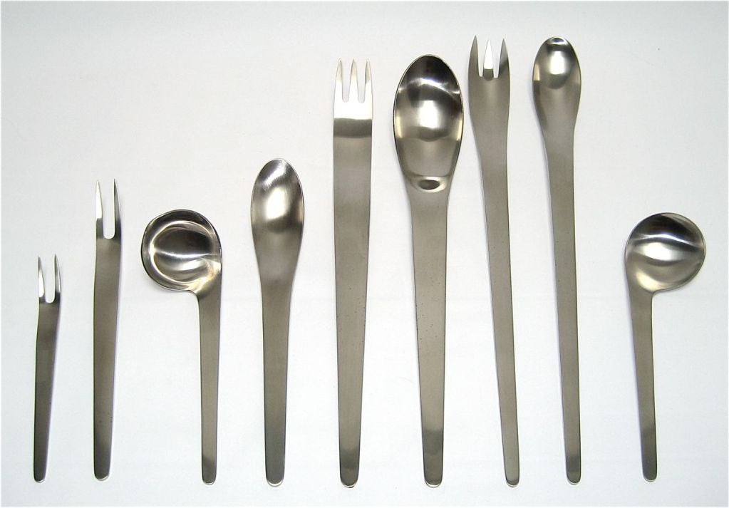 Stainless flatware complete service for eight plus one left handed soup spoon, (65 pieces) two serving spoons, sauce ladle, serving fork, salad set, four condiment forks, (12 pieces) total of 75 pieces. In original case.  
Literature: Arne
