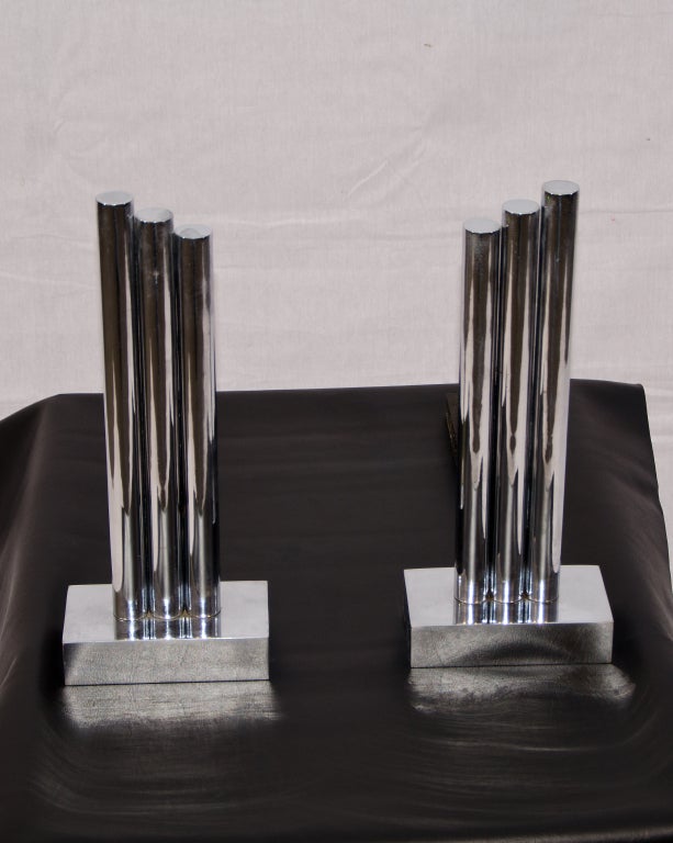 Great looking pair of mid century chrome andirons. Would look good in many interior styles. A classic Art Deco skyscraper  appearance.