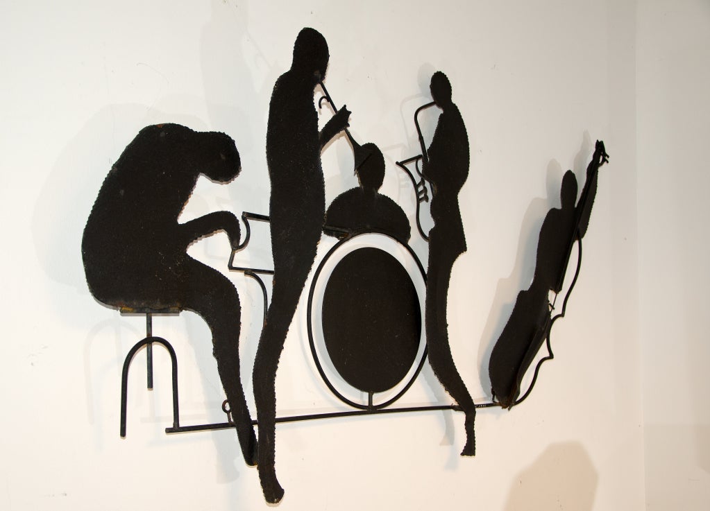 Black metal C. Jere sculpture of band members playing different instruments. Band comprised of  a piano, trumpet, drums, saxophone, and base. Signed C. Jere 1991