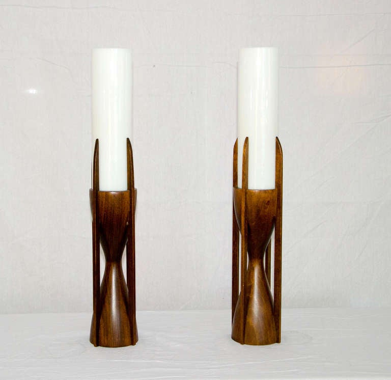 This unusual pair of lamps would be great accent lighting. Original finish on the walnut bases. The white opal glass tubular shades measure 3