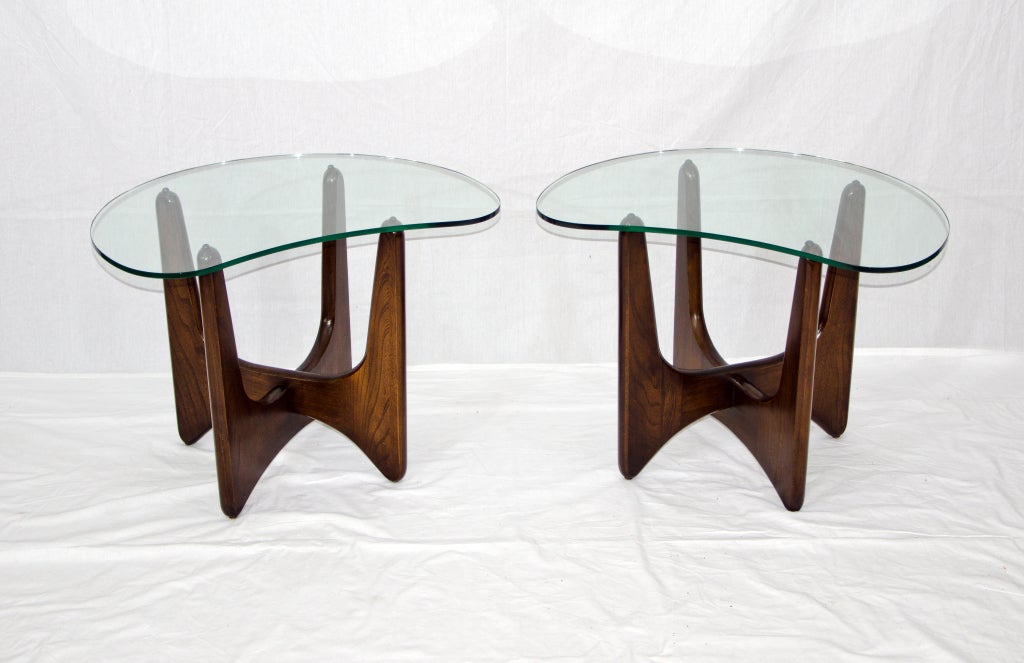 Great pair of mid century end tables in the style of Adrian Pearsall. Wood bases have a walnut colored finish. Tops are a kidney shaped and about 5/16