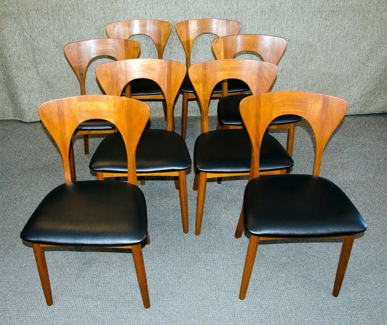This hard to find set of eight Keofoeds Hornslet Danish teak dining chairs have a great curved design and are very comfortable. The backs of the chairs are slightly curved. Very solid teak construction. Information found on the internet describes
