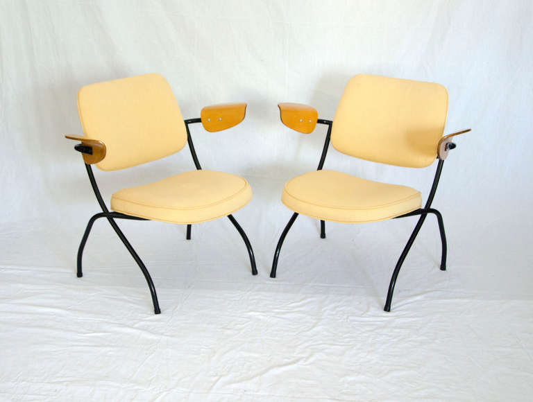 Quirky pair of smaller scale lounge chairs with a somewhat industrial look. Consists of a metal framework, upholstered seats and backs with bent ply armrests, very comfortable. Reupholstery services with your choice of fabric available. Seat cushion