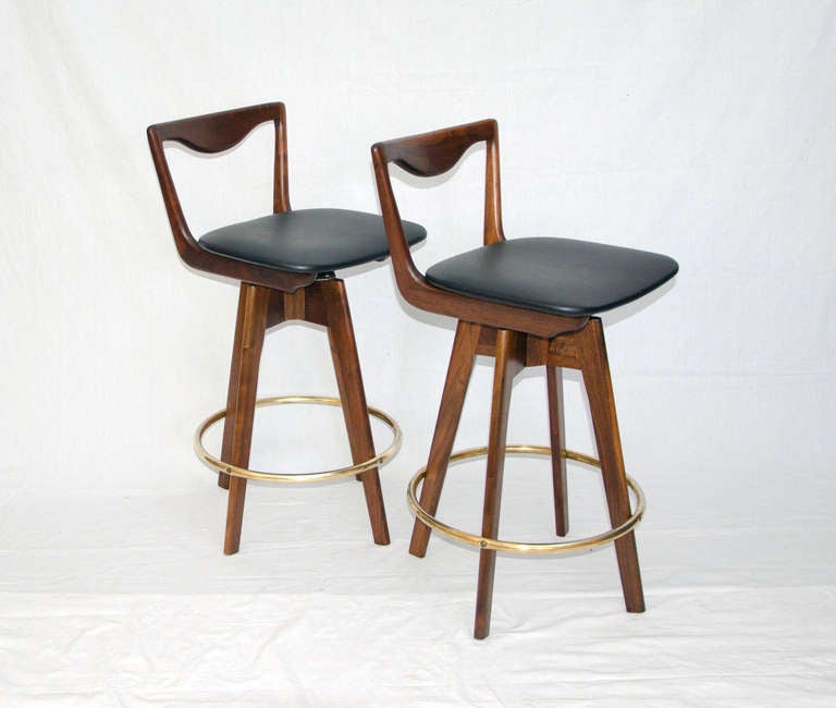 Swiveling bar stools have comfortable size seats as well as a circular foot-rail.