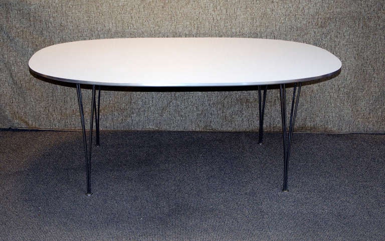 Stylish white laminate super ellipse table manufactured by Fritz Hansen and designed by Piet Hein and Bruno Mathsson. Nice low maintenance table for dining room or in a conference  room. Purchased in Denmark by the original owners while employed at
