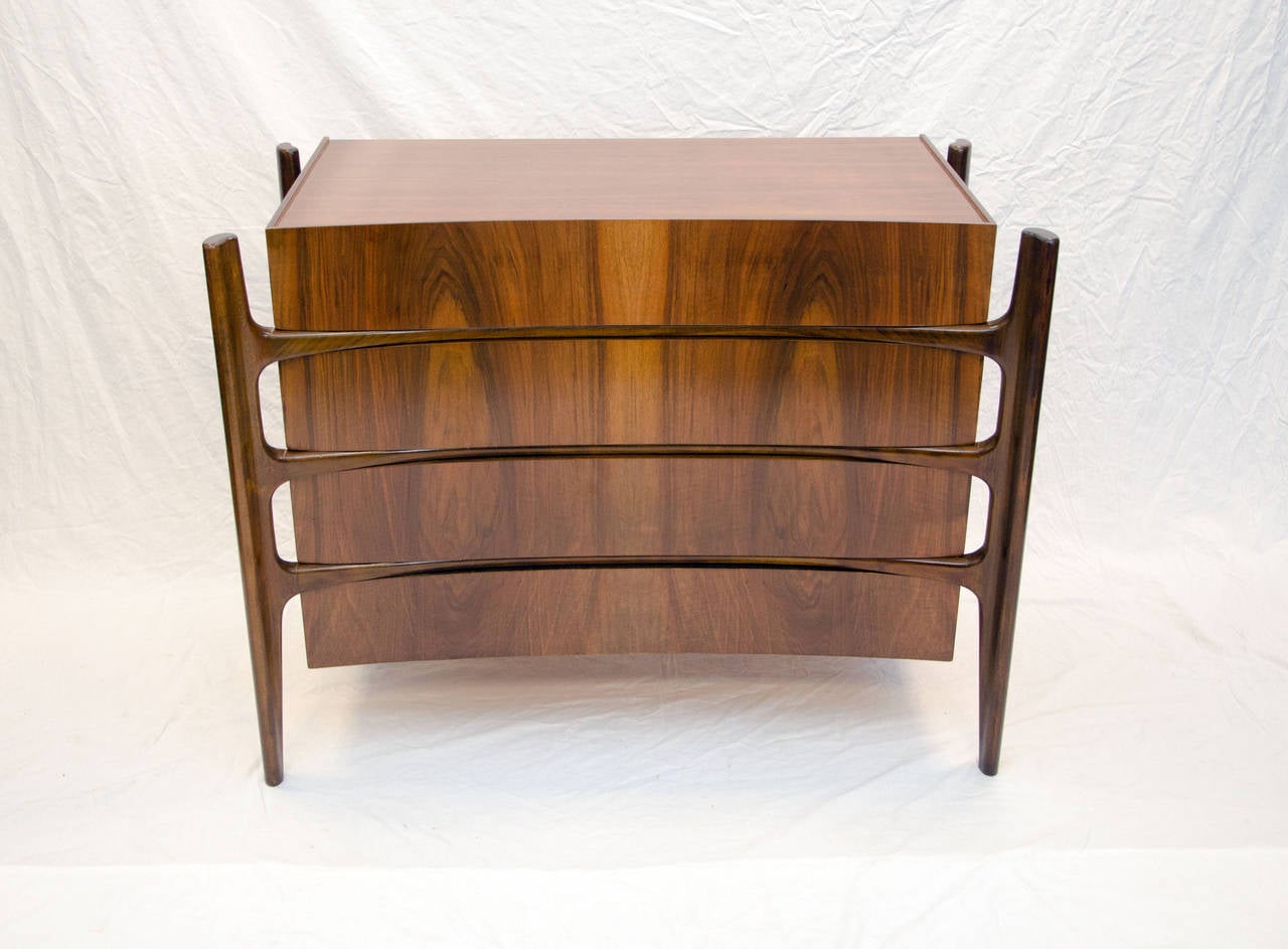 Very unusual dresser designed with an exterior curved framework. Drawer fronts have beautiful book-matched grain patterns.  Made in Sweden by The Swedish Furniture Guild for Urban Furniture c. 1950. Often misattributed to Edmond Spence.