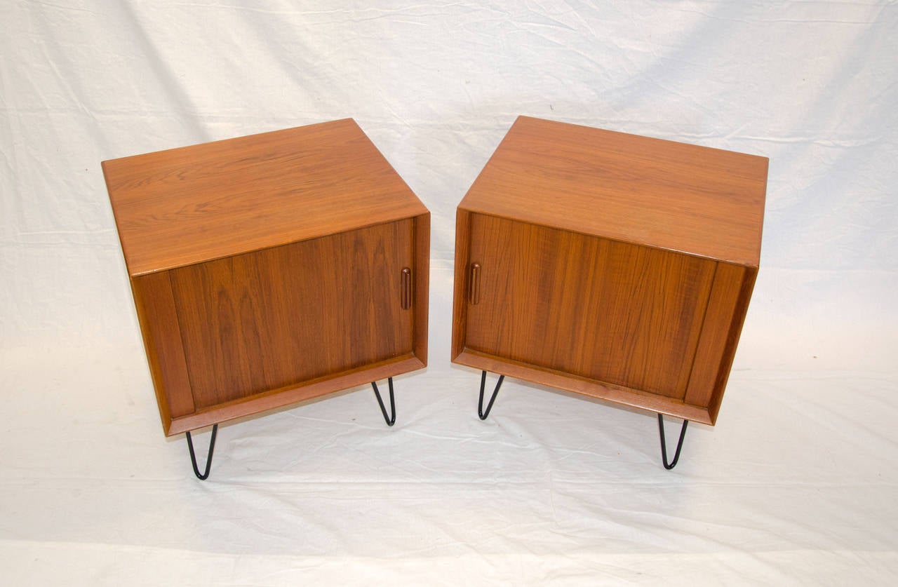 Nice pair of Danish teak nightstands with tambour doors, interior is birch and has one shallow drawer and an adjustable shelf. Retains the 