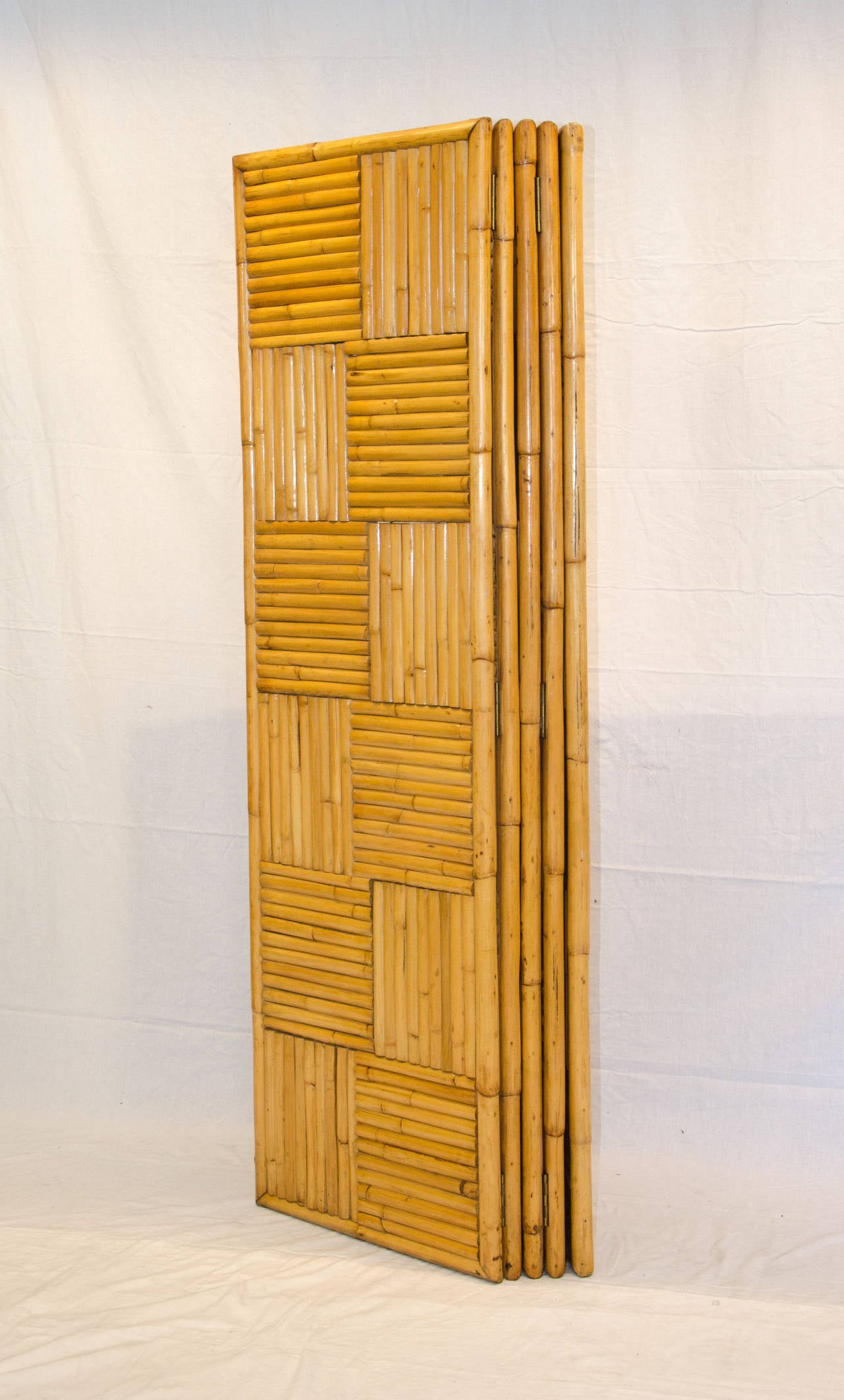 Very nice five panel rattan screen very useful as a room divider or for separating a part of a space, would be great in a tropical or tiki atmosphere, as well as an Asian motif. Each panel is 20