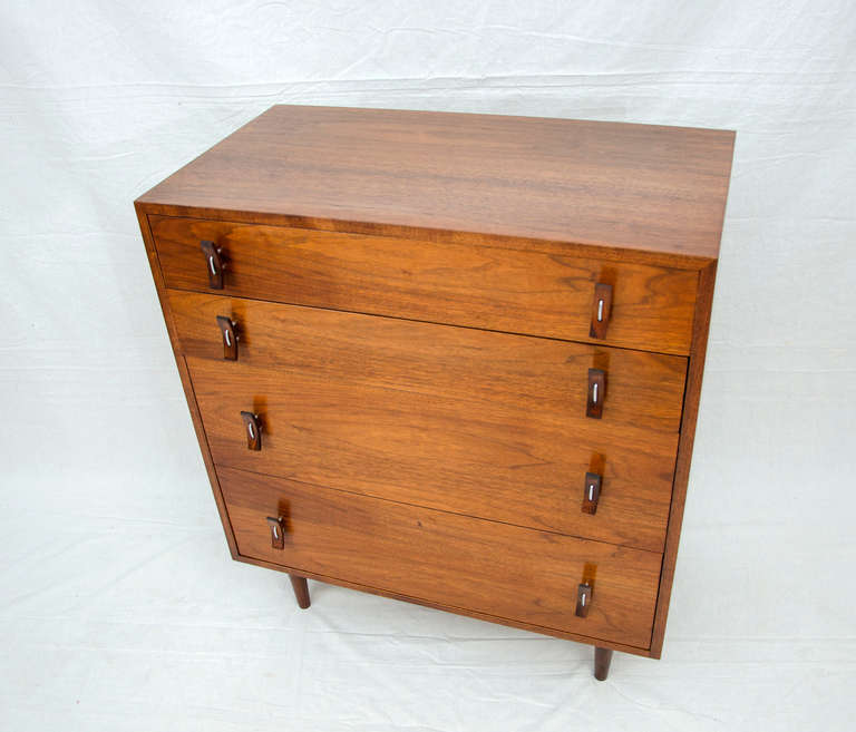 Four drawer Glenn of California manufactured chest designed by Stanley Young. Unusual size, nice quality construction with oak drawer interiors. Two bottom drawers deeper than the two top drawers.