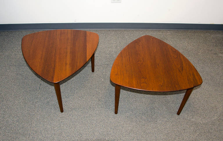 Quality pair of solid teak occasional tables. Good size to place beside or between lounge chairs, or for a matched pair of coffee tables. Round tapered legs unscrew for economical shipping. Stamped into table bottoms: 