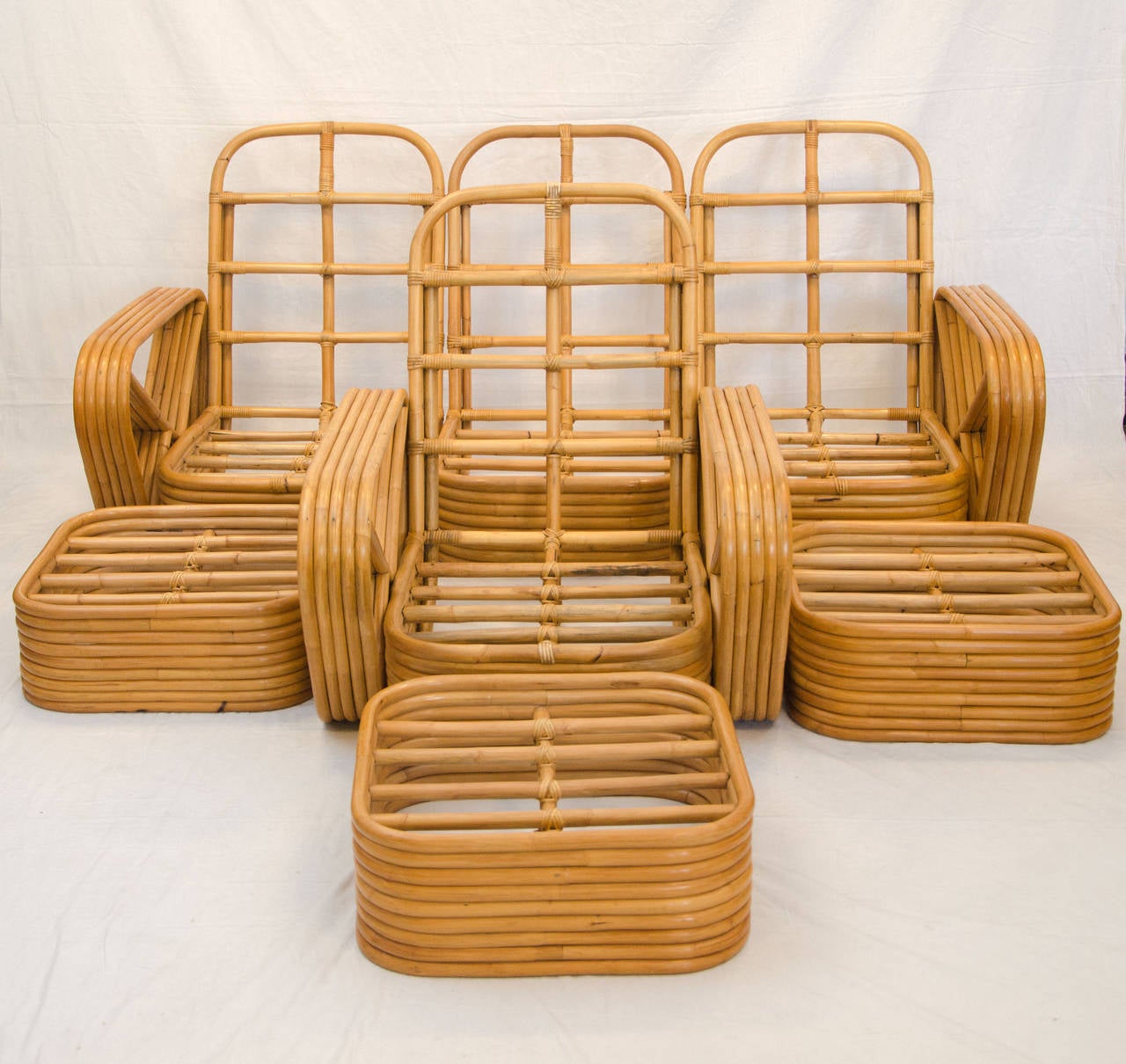 Very nice five band rattan 3 piece sectional sofa, arm chair and 3 ottomans, the sofa can also be a loveseat and one armless chair. Original manufactures tag attached 
