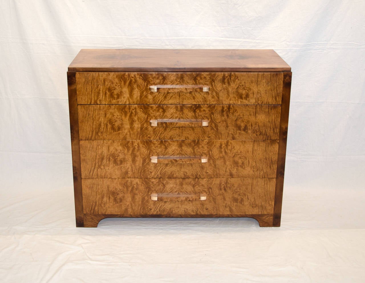 Beautiful burled walnut Art Deco chest of drawers attributed to Donald Deskey and manufactured by Widdicomb. Drawer bottoms are made of mahogany and have ample storage space with a graduated depth of 4