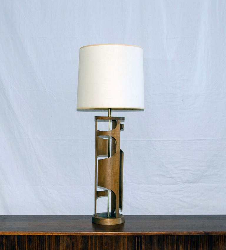 Very unusual organic shaped walnut lamp base nice linen look shade. Accented by a thin brass rod from base to light socket. Retains the original Modeline Company tag.