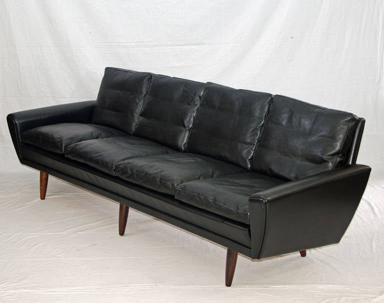 Fabulous extra length Danish sofa with original leather upholstery. Retains foil 