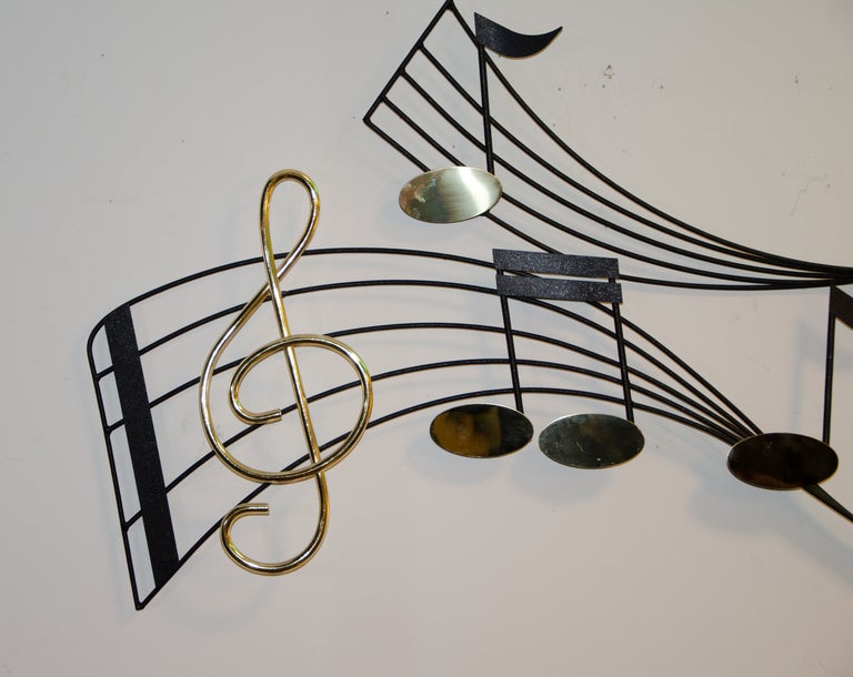 Nice musical note metal wall sculpture in the style of C. Jere. Signature on one note but it's not legible.