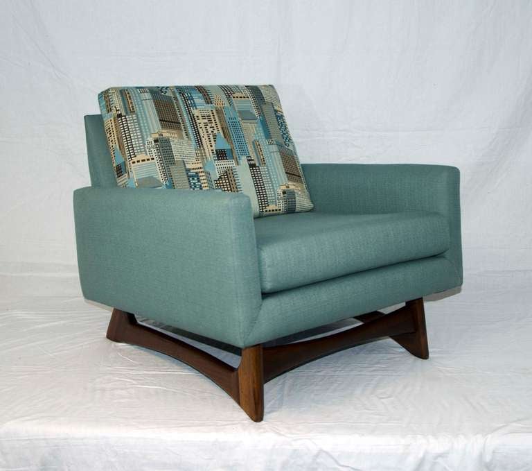 Comfortable lounge chair newly upholstered. Chair floats on an Adrian Pearsall designed solid walnut base. Loose cushions on back and seat. Fun skyscraper motif on back cushion. Seat cushion is 24