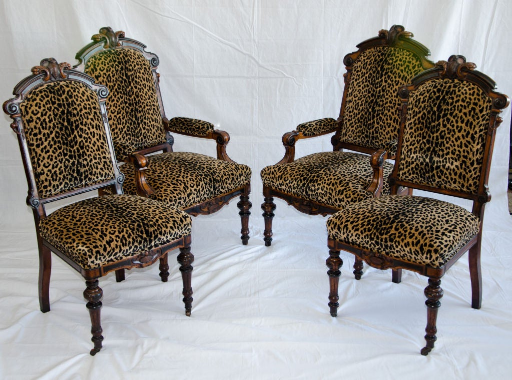 Wonderful set of 19th century American renaissance Victorian Walnut dining chairs. Very comfortable chairs paired with a circular Walnut dining table in a separate post.Beautiful details and new leopard upholstery. Armchairs are 44