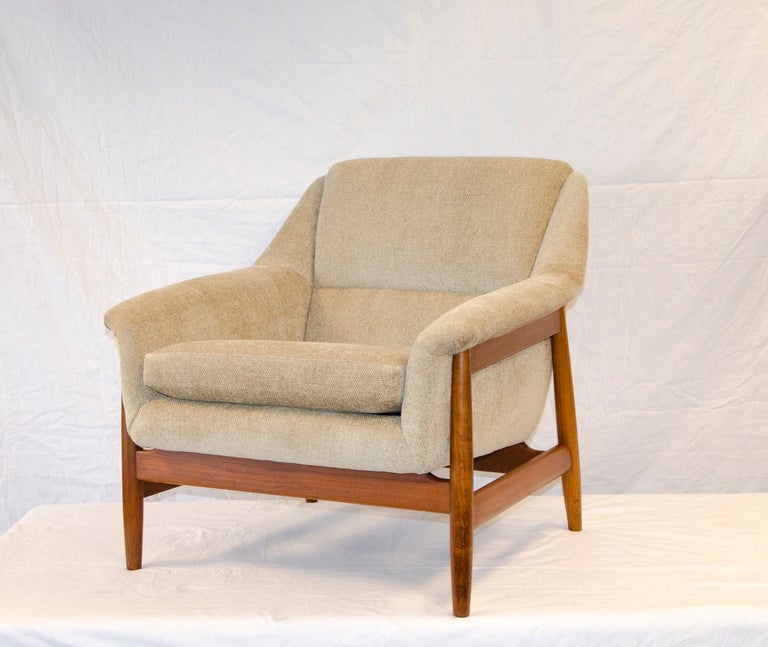 Comfortable Dux style lounge chair chair on a teak wood framework, nice medium size. Norwegian company's tags re-attached after re-upholstery was completed. 
Cushion size is 20