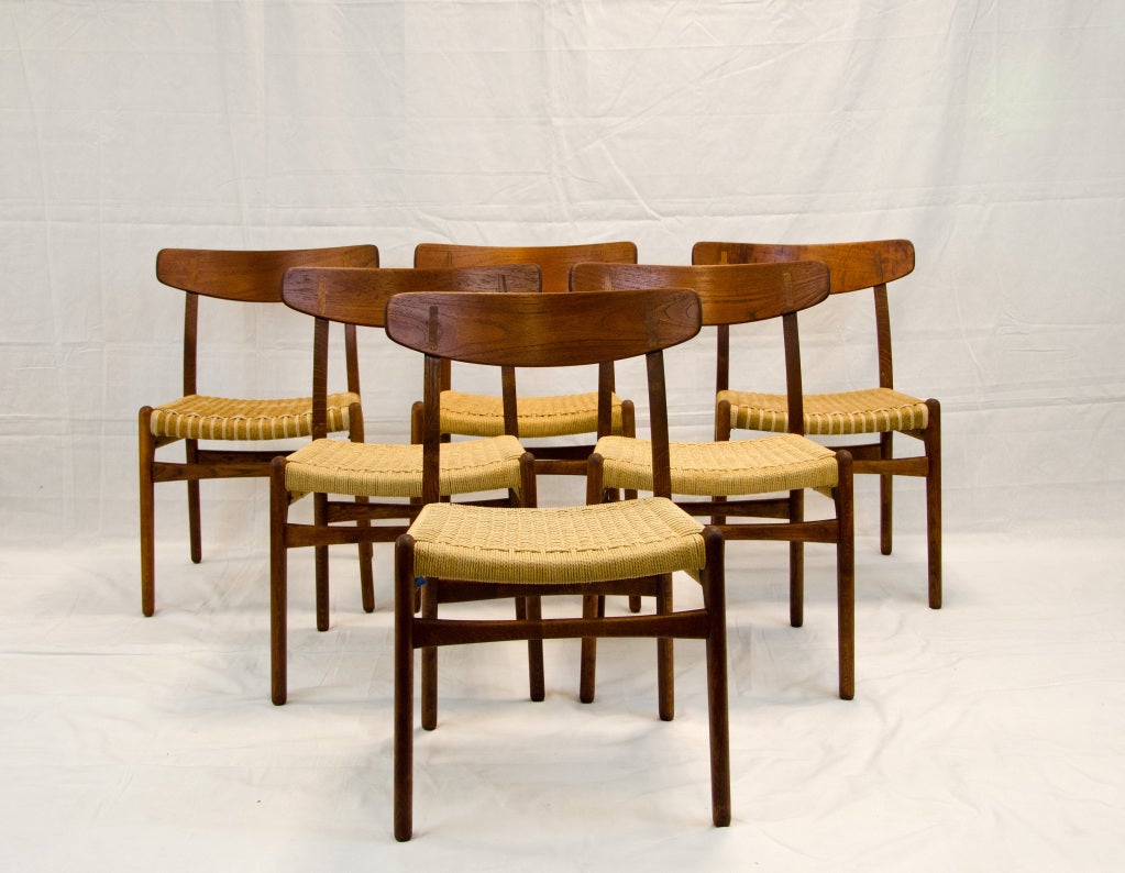 Nice set of six Danish dining chairs designed by Hans Wegner and manufactured by Carl Hansen & Son. Four chairs have original paper cord seats and two have partial cord seat restoration. Frames are Oak, back is Teak with Oak insert. One chair is