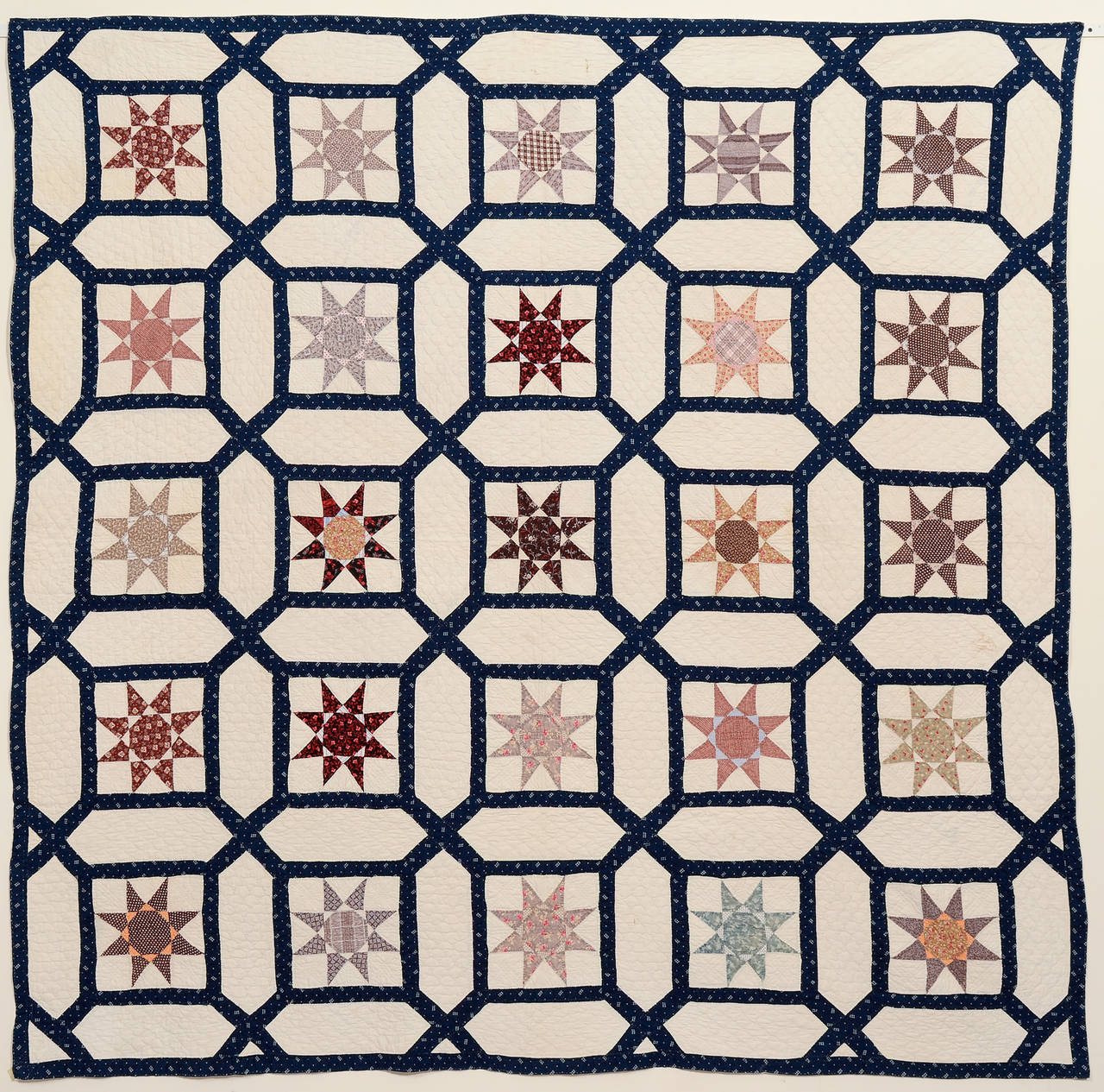 This interesting quilt actually combines three different patterns. The garden maze is filled with eight point stars within which are the obscure pattern known as the car wheel. The car wheels are made of a nice variety of late 19th century printed