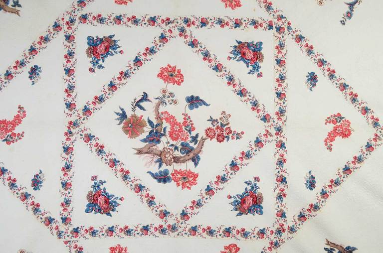 Elegant center medallion chintz applique quilt in rich tones of reds and blues.  It is very finely stipple quilted. The body  of the quilt is in excellent condition. There is some weakness to the fabric on the outermost edge. Measurements are 100
