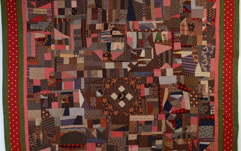 This Cotton Crazy Quilt is truly a collage of fabrics. The center has the structure of a Nine Patch within a Diamond in a Square. This unusual touch pulls in your eye before wandering around the composition of irregularly shaped pieces. It is made