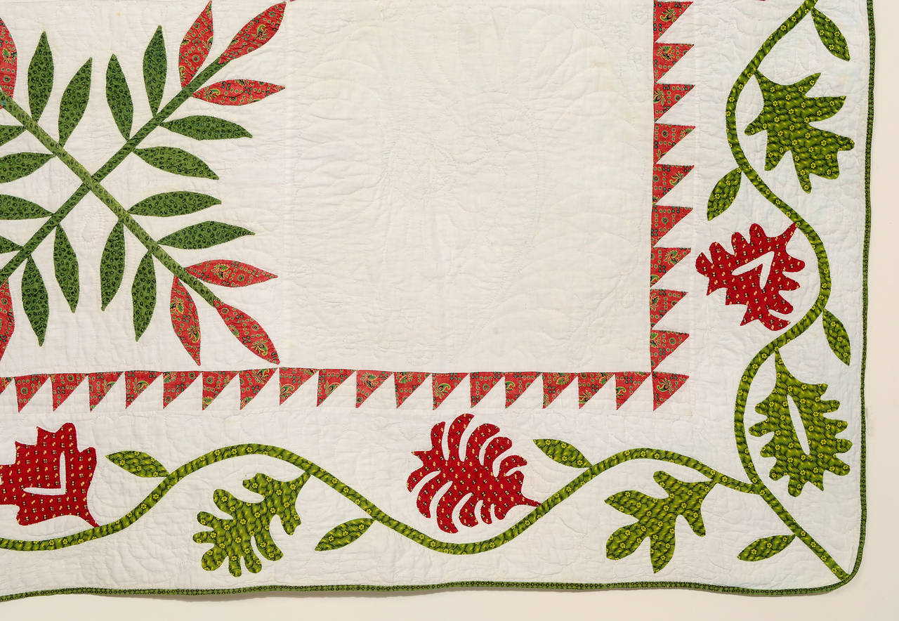 Well made classic crossed flowers Laurel Leaf quilt. It's interesting that the maker chose a totally different type of leaf for the applique and reverse applique border. The thin batting makes the quilting difficult to photograph but it is very well