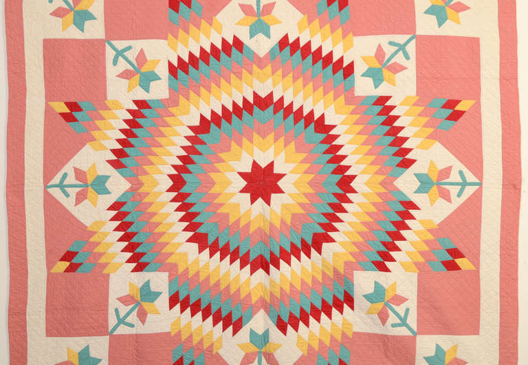 This dynamic quilt is made of a unique combination of Lone Star (aka Star of Bethlehem) and Tulip patterns. The way in which the tulips are placed around the star gives the overall pattern a whole different outline. Continued placement of the tulips