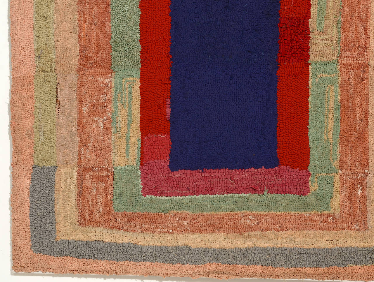 This homemade hooked rug predates by at least 15 years the Homage to the Square series of paintings by famed artist Josef Albers. The similarity, though, is unmistakable. This rug is hooked of a variety of cotton and wool fabrics. It is loosely