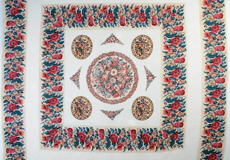 It is difficult to imagine a more lush garden of chintz fabrics, exquisitely placed together. The maker cleverly created an open diamond in the center frame which is the perfect transition from the straight lines of the outer borders to the circles