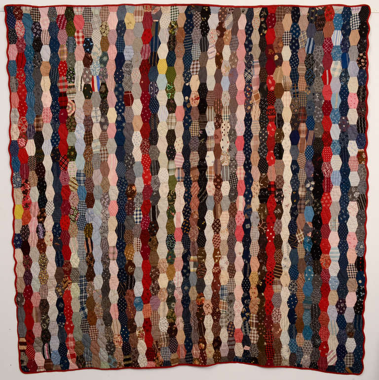 Elongated hexagons are combined to form bands of color in this unusual quilt. What makes it most unusual is that it is a charm quilt, meaning that none of the fabrics are repeated. It is truly a library of fabrics of the late 19th century.