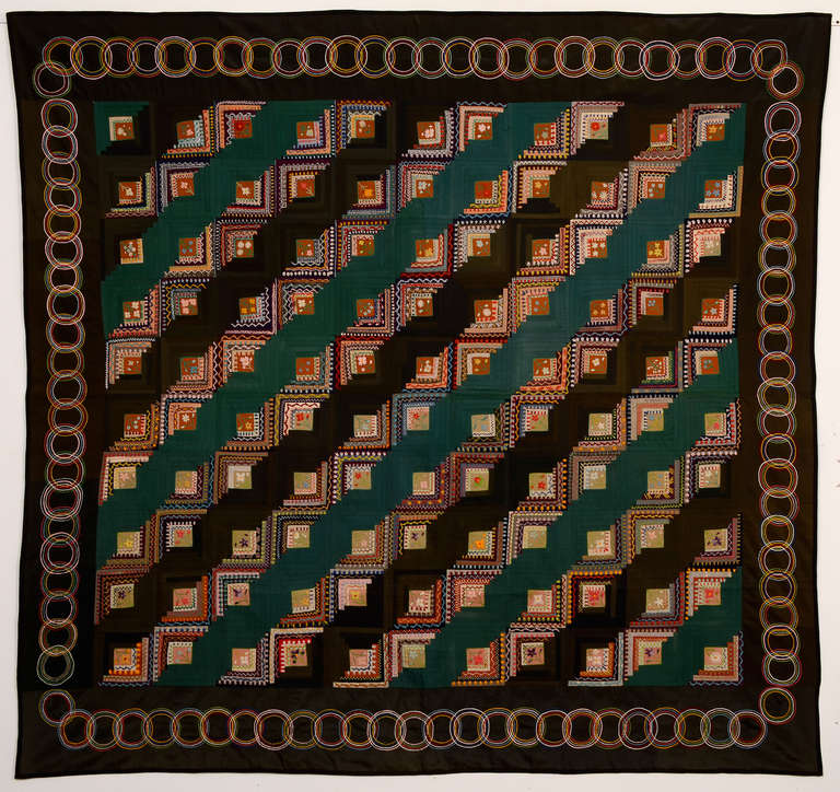 This Straight Furrows Log Cabin quilt is embellished unlike any other I've seen. The centers of each block are embroidered with a variety of flowers. Each log is embroidered with a tremendous number of abstract patterns and the overlapping circles