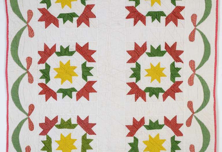 This Victory Star Crib Quilt also goes by the pattern names of Hands All Around and Yankee Pride. Regardless of the name, a Lemoyne Star sits at the center of eight half stars. The geometry of the pattern is nicely balanced by a swag border. Several