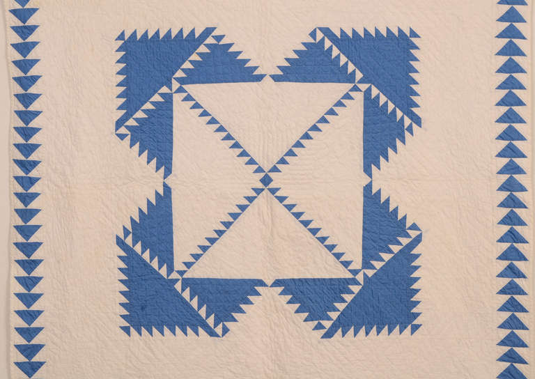 Finely quilted Delectable Mountains crib quilt from the 1920's. The blue is more of a cornflower shade than may appear on the monitor. The Wild Goose Chase border is a clever way of continuing the triangle theme with a different, compatible pattern.