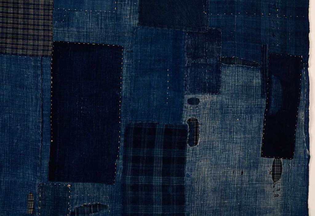 This Japanese boro was tenderly made to preserve a futon cover in the late 19th century. Hand dyed indigo cottons are pieced and appliqued, creating a new surface far more exciting than the original. It was made by a humble family to maximize and