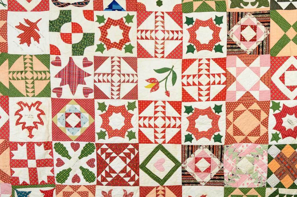 This unique Sampler Quilt has both traditional and original blocks, many with hearts as an indication of the affection with which it was made. Written in ink it says 