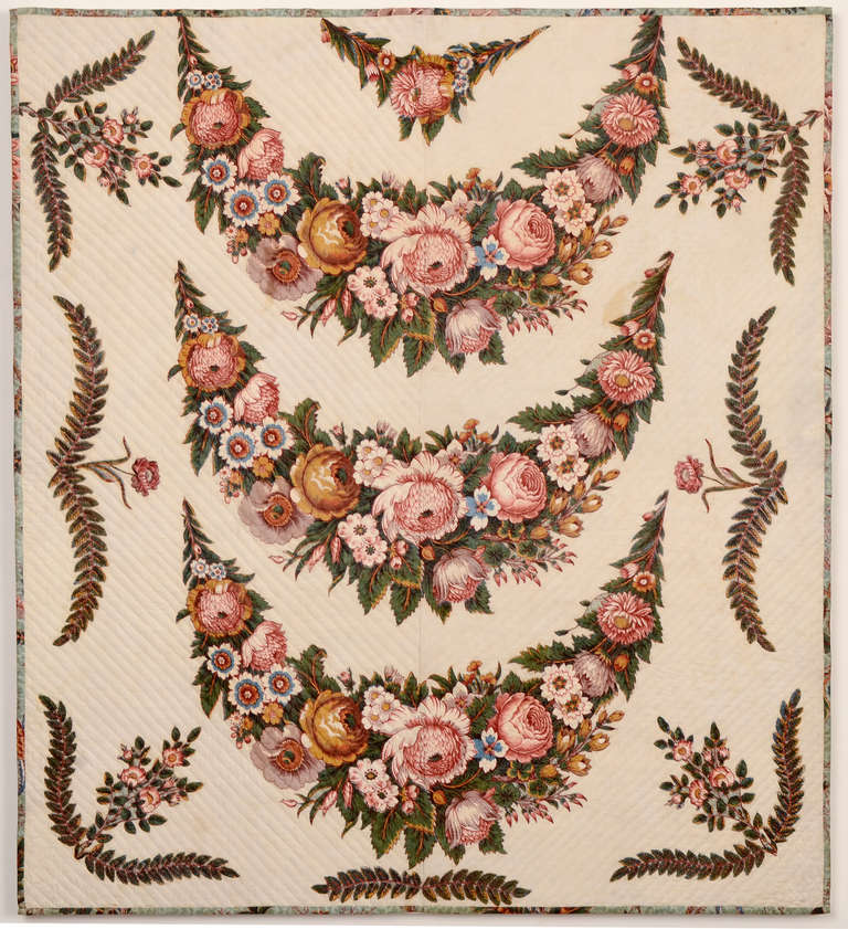 Rarely does one find a broderie perse (chintz applique) crib size quilt and certainly not with the graceful and full design of this fine example. It is richly colored with the appearance of considerable depth to the garlands of flowers. The chintz