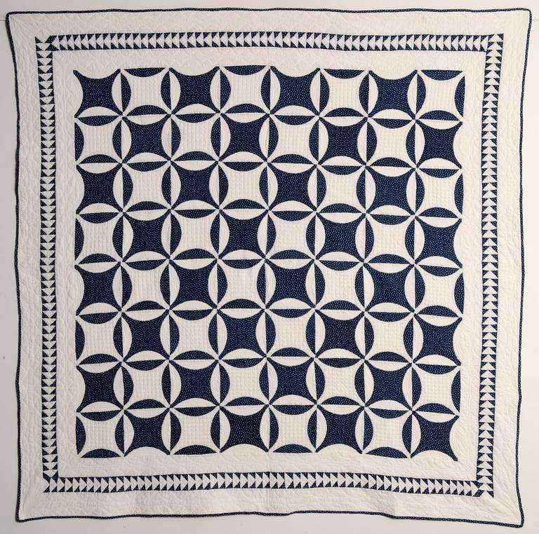 The classic Robbing Peter to Pay Paul (aka Lemon Peel) quilt pattern is enhanced by the small scale Flying Gees border. The angles of the border pattern are an interesting counterpoint to the curves of the primary one. The quilt is in pristine,