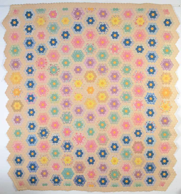 Grandmother's Flower Garden was one of the most popular patterns of the 1930's. This is a particularly fine example because of the organized, symmetrical use of color as well as the small size of the gardens. In addition, it is done on an ecru