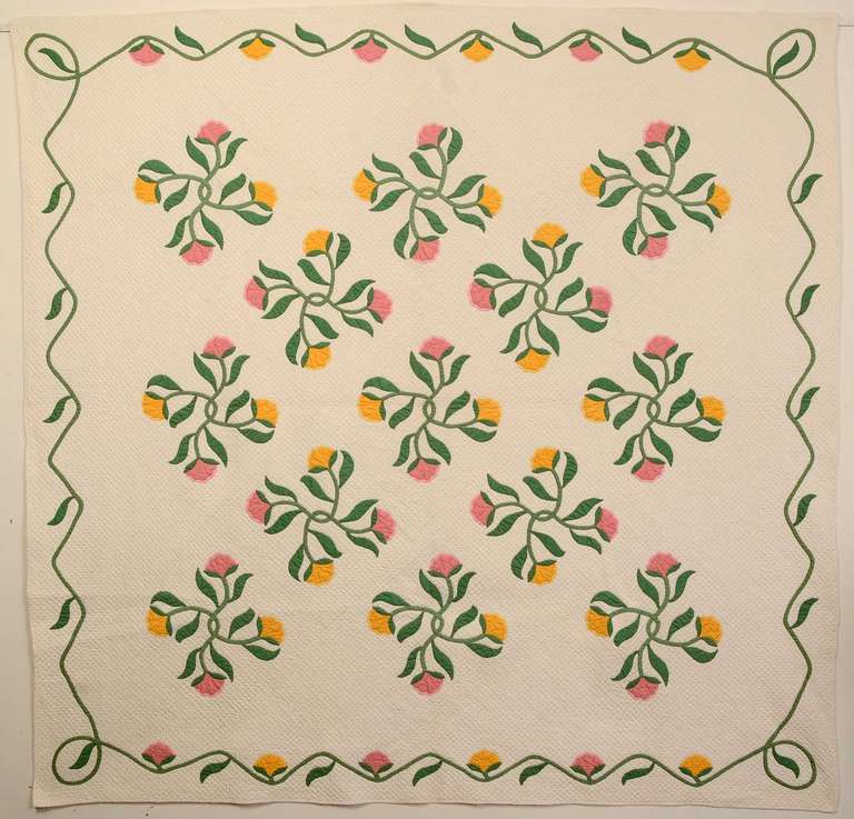 This graceful Crossed Flowers applique quilt appears to be an original pattern. It is densely quilted with a waffle design throughout. The squares measure a mere 1/2