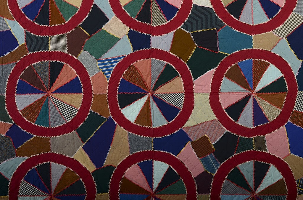 This unusual Mennonite Quilt appears to superimpose circles on the background of a crazy quilt. It is a wonderful balance between order and 