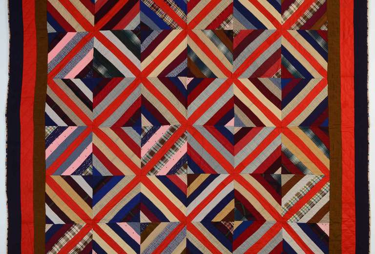 Intense Kaleidoscope pattern quilt made of medium weight wools. The central red stripe of the triple border is especially effective in carrying through the criss crosses of the same red used throughout the quilt. Excellent condition. Pennsylvania