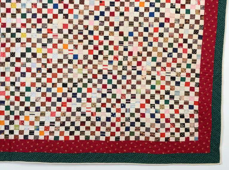 Postage Stamp quilt with a wide variety of late 19th century fabrics. The two borders have the latest fabrics, dating to the date to 1880's or 90's. Alternating the printed blocks with white ones gives the overall pattern a nice twinkle. It is in