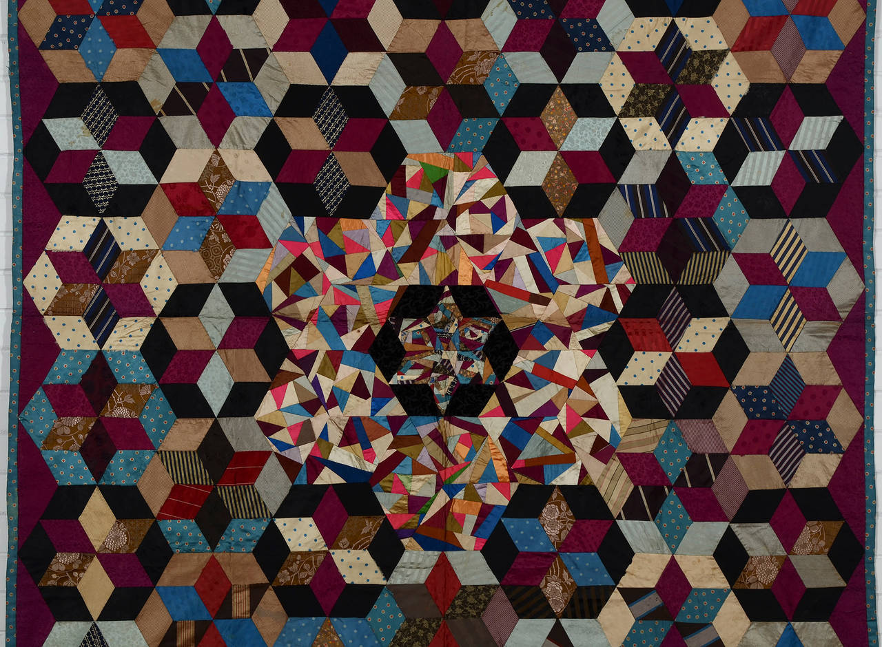 This unusual Victorian silk quilt beautifully combines several patterns. It has Tumbling Blocks; Stars; Hexagons and Crazy. In addition to emphasizing the hexagon, the  use of light colors for the Crazy pattern creates a halo effect around the