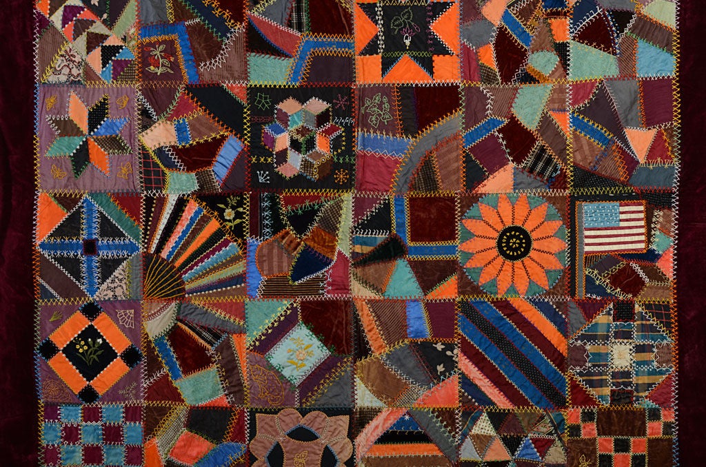 This unusual quilt combines half Crazy blocks with the other half a variety of patterns making a Sampler Quilt. Made mostly of velvets with some satin. Both the colors and fabrics combine to give rich, jewel tones. Embroidered with a variety of