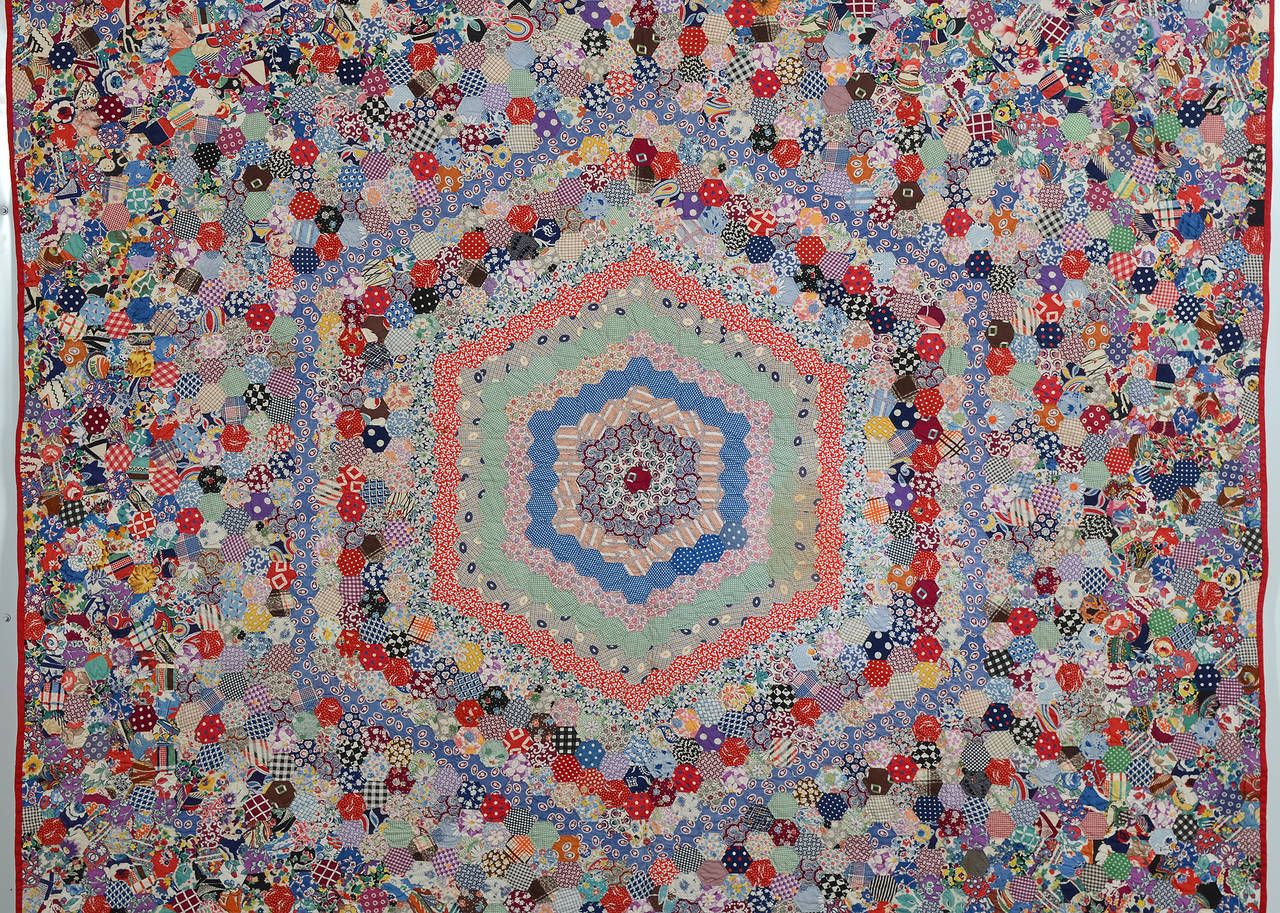 This hexagons quilt  is actually the same block throughout but the change of color gives it a definite center medallion. It is in pristine, unwashed condition . The quilt is made of a tremendous variety of late 1930s printed fabrics, many of which