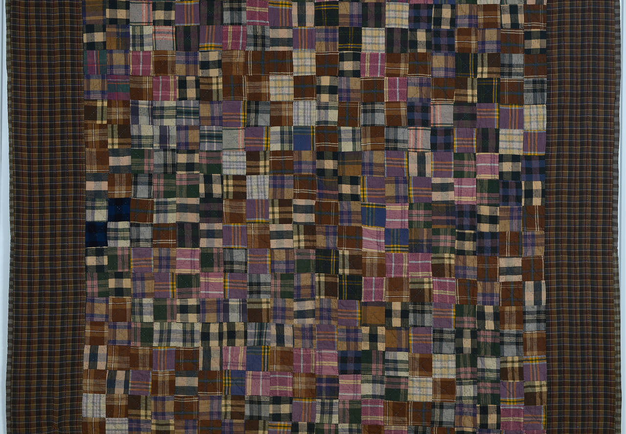 This one-patch quilt made almost entirely of plaid cotton flannels is both simple and sophisticated. It took an artistic eye to put together this large combination of plaids in a palette of mauves, grays and browns. The four deep indigo squares are