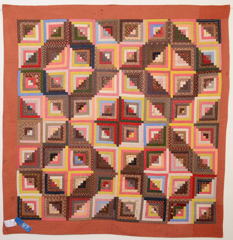 Beautifully made Light and Dark Log Cabin quilt in a variety of late 19th century calico fabrics. They are well placed using the browns to create  the diamonds  and particularly carefully done in the  middle creating a square around the central