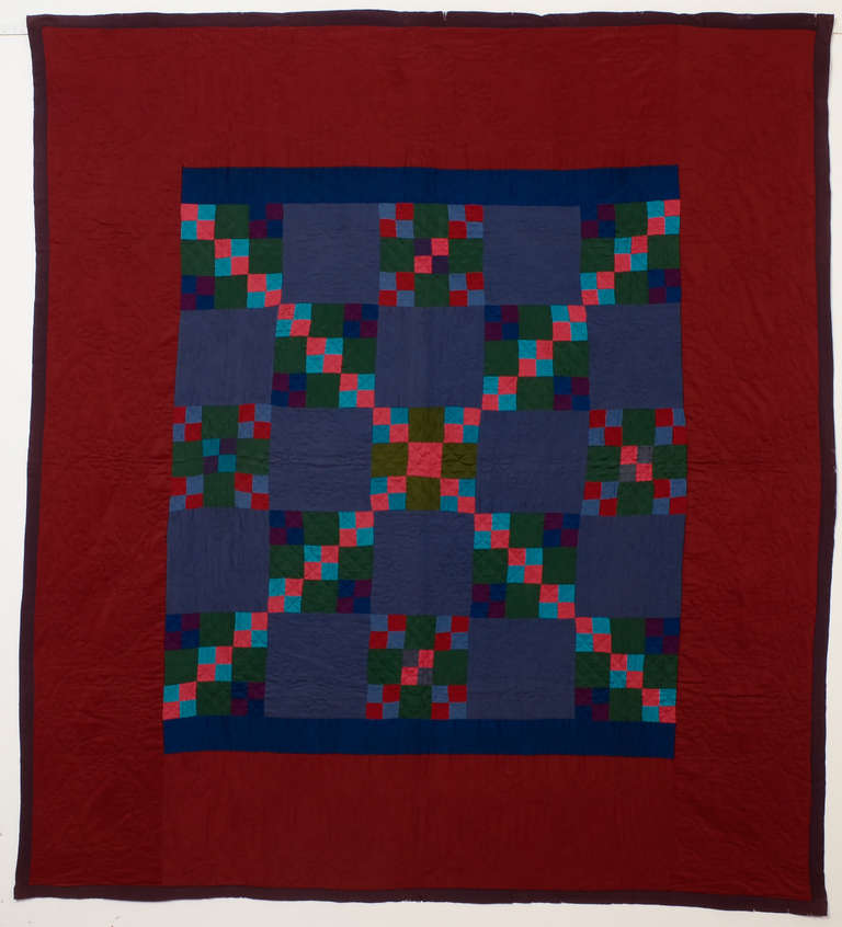 This Lancaster County Amish four patch in a nine patch quilt is brilliantly arranged.The maker used the same colors throughout but placed them so as to create the unusual overall X pattern. This might be a one of a kind.
The solid color blocks and